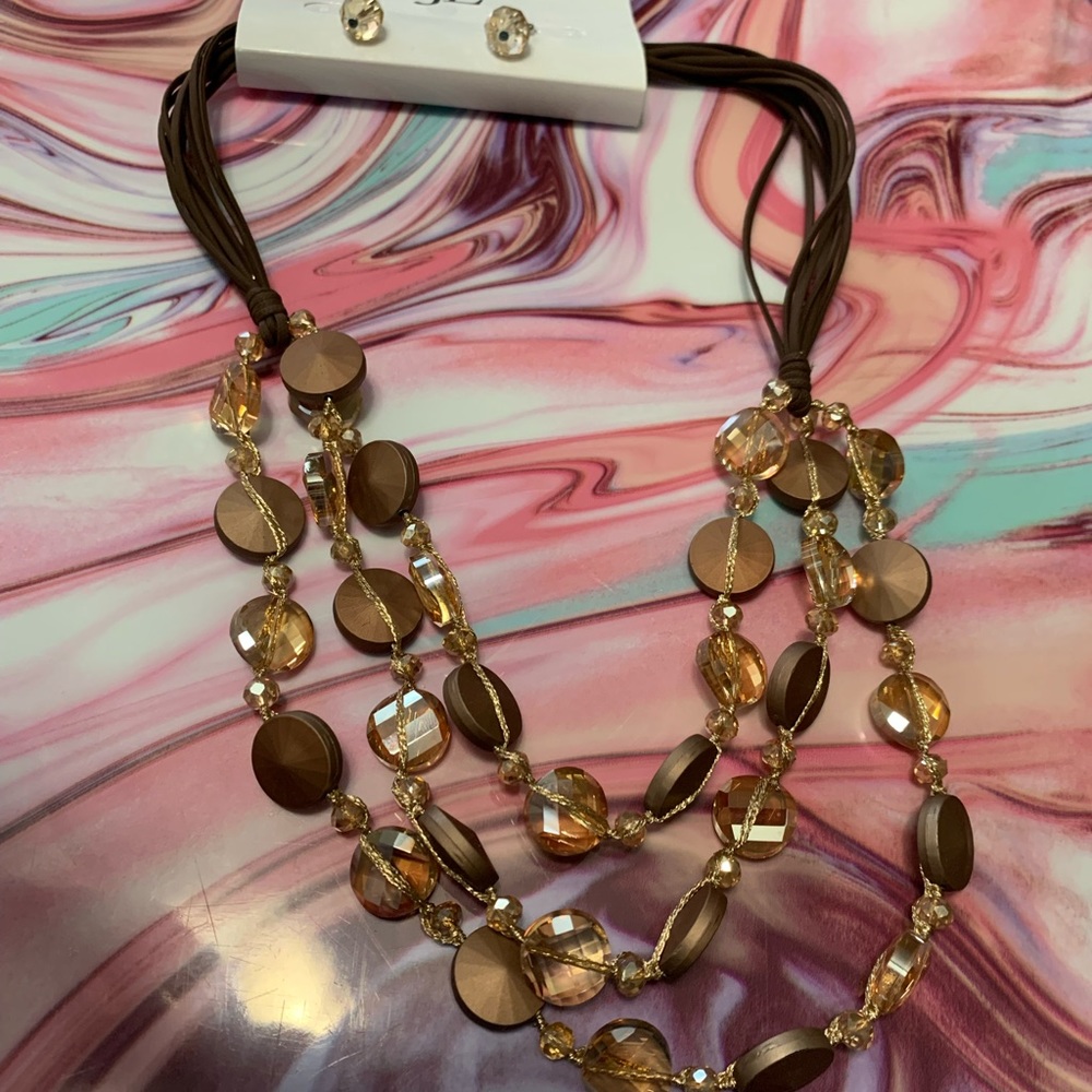Three strand gold and beige tone necklace with earrings.